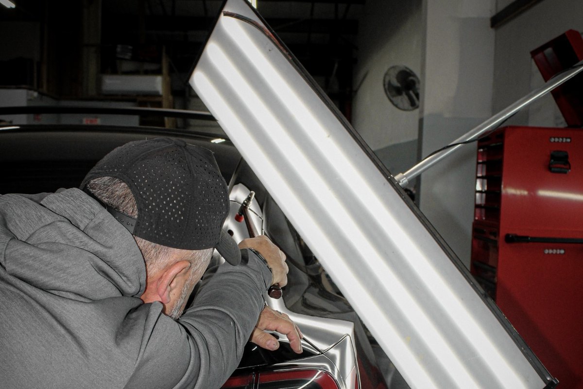 Paintless dent repair being performed